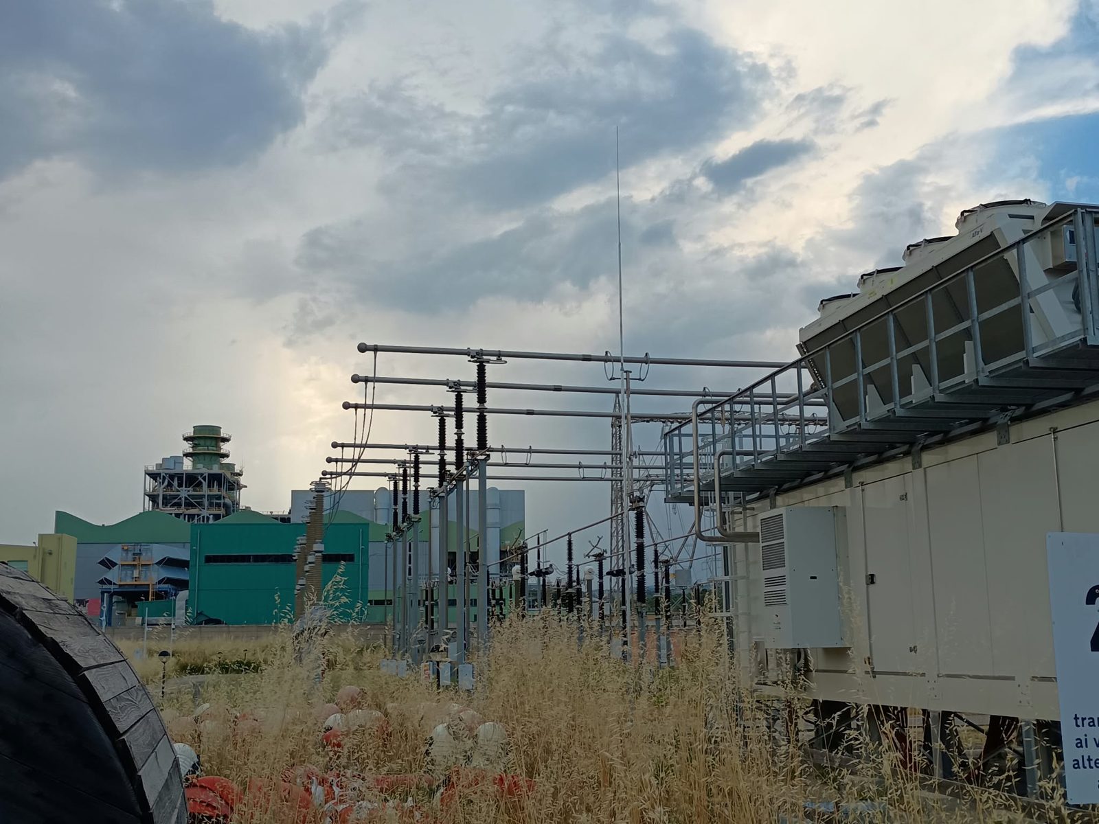 Sottostazione elettrica con centrale sullo sfondo